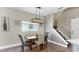 Dining room features modern chandelier and hardwood floors at 4002 Carrollwood Palm Ct, Tampa, FL 33624