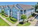 View of a stylish, two-story home featuring a balcony and well-maintained landscaping at 4002 Carrollwood Palm Ct, Tampa, FL 33624