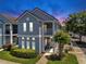 Charming two-story townhouse featuring a balcony, white trim, and a well-maintained lawn at 4002 Carrollwood Palm Ct, Tampa, FL 33624