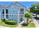 Charming blue two-story home with a private balcony and well-maintained landscaping at 4002 Carrollwood Palm Ct, Tampa, FL 33624