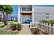 Charming front porch featuring a white picket fence, inviting chairs, and well-manicured landscaping at 4002 Carrollwood Palm Ct, Tampa, FL 33624