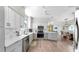 Bright kitchen features stainless steel appliances, white cabinets, subway tile backsplash, and hardwood floors at 4002 Carrollwood Palm Ct, Tampa, FL 33624