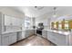 Modern kitchen features stainless steel appliances, white countertops, and grey and white cabinetry at 4002 Carrollwood Palm Ct, Tampa, FL 33624