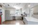 Well-equipped kitchen with stainless steel appliances, white subway tile backsplash, and modern lighting at 4002 Carrollwood Palm Ct, Tampa, FL 33624