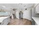 Open kitchen layout featuring a breakfast bar, stainless steel appliances, and hardwood floors at 4002 Carrollwood Palm Ct, Tampa, FL 33624