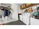 Functional laundry room features a washer, dryer, and plenty of shelving for storage at 4002 Carrollwood Palm Ct, Tampa, FL 33624
