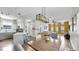 Open-concept living area with kitchen access, modern lighting, and stylish furniture at 4002 Carrollwood Palm Ct, Tampa, FL 33624