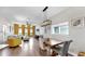 Open-concept living and dining area with modern lighting, hardwood flooring, and contemporary decor at 4002 Carrollwood Palm Ct, Tampa, FL 33624