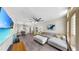 Inviting living area with ample seating, an open floor plan, and a large flat-screen TV at 4002 Carrollwood Palm Ct, Tampa, FL 33624