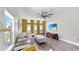 Comfortable living room with a large sectional, hardwood floors, and a modern ceiling fan at 4002 Carrollwood Palm Ct, Tampa, FL 33624