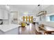Living space with hardwood floors, comfortable seating, yellow accent wall, and open floor plan at 4002 Carrollwood Palm Ct, Tampa, FL 33624