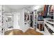 Spacious walk-in closet with custom shelving and storage, leading to the ensuite bathroom with modern fixtures at 4002 Carrollwood Palm Ct, Tampa, FL 33624