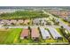 Aerial view of a community with beautiful homes, a central lake, and lush green spaces at 4257 Rosatti Rd, Wesley Chapel, FL 33543