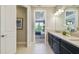 Well-lit bathroom leading to a bedroom with a king-sized bed, stylish decor and a comfortable space at 4257 Rosatti Rd, Wesley Chapel, FL 33543