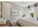 Bright bedroom featuring two pieces of modern art, soft window lighting, and simple decor at 4257 Rosatti Rd, Wesley Chapel, FL 33543