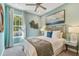Stylish bedroom features a cozy bed, decorative wall art, and a large window at 4257 Rosatti Rd, Wesley Chapel, FL 33543