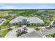Stunning aerial view of a modern clubhouse with lush landscaping, pool, and tennis courts in a vibrant community at 4257 Rosatti Rd, Wesley Chapel, FL 33543