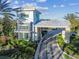 Community entrance with a gated entry, lush landscaping, and attractive architecture at 4257 Rosatti Rd, Wesley Chapel, FL 33543