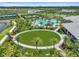 Lush green circle surrounded by tennis courts, pool, and clubhouse in a beautiful Primary-planned community at 4257 Rosatti Rd, Wesley Chapel, FL 33543