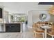 Open-concept space with a dining table, kitchen island with seating, and a view of the living room at 4257 Rosatti Rd, Wesley Chapel, FL 33543