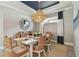 Elegant dining room features stylish lighting, decor, and comfortable seating for six at 4257 Rosatti Rd, Wesley Chapel, FL 33543