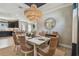 Dining area features a stylish light fixture and a view into the kitchen and living space at 4257 Rosatti Rd, Wesley Chapel, FL 33543