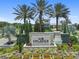 Entrance to Esplanade at Wiregrass Ranch with lush landscaping and palm trees at 4257 Rosatti Rd, Wesley Chapel, FL 33543