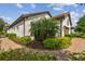 Charming home exterior with manicured landscaping, brick walkway and a tile roof at 4257 Rosatti Rd, Wesley Chapel, FL 33543