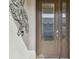 Elegant front door with decorative glass, modern door hardware, and doorbell camera at 4257 Rosatti Rd, Wesley Chapel, FL 33543