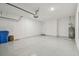 Two-car garage featuring an epoxy floor, water heater, and ample space for storage at 4257 Rosatti Rd, Wesley Chapel, FL 33543