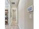 Hallway with wood floors, neutral walls, recessed lighting, and home monitoring system at 4257 Rosatti Rd, Wesley Chapel, FL 33543