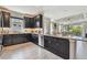 Stylish kitchen with dark wood cabinets, quartz countertops, stainless steel appliances, and an open layout at 4257 Rosatti Rd, Wesley Chapel, FL 33543