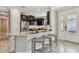 Well-lit kitchen features dark cabinets, stainless steel appliances, and a breakfast bar at 4257 Rosatti Rd, Wesley Chapel, FL 33543