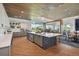 Bright kitchen island with a built-in beverage cooler and a pendant lighting arrangement at 4257 Rosatti Rd, Wesley Chapel, FL 33543