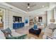 Bright living room featuring hardwood floors, neutral walls, recessed lighting, ceiling fan, and modern furniture at 4257 Rosatti Rd, Wesley Chapel, FL 33543
