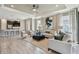 Bright living room featuring hardwood floors, neutral walls, recessed lighting, ceiling fan, and modern furniture at 4257 Rosatti Rd, Wesley Chapel, FL 33543