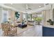 Bright living room featuring hardwood floors, neutral walls, recessed lighting, ceiling fan, and modern furniture at 4257 Rosatti Rd, Wesley Chapel, FL 33543