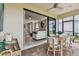 Cozy screened patio with an inviting dining space, seamlessly blending indoor comfort with outdoor views at 4257 Rosatti Rd, Wesley Chapel, FL 33543