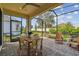 Relaxing screened patio featuring a dining table and chairs, plus additional seating for outdoor enjoyment at 4257 Rosatti Rd, Wesley Chapel, FL 33543