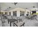 A covered outdoor patio seating area with views and ceiling fans at 4257 Rosatti Rd, Wesley Chapel, FL 33543