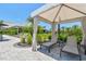 Relaxing poolside cabana with lounge chairs, providing shade and comfort at 4257 Rosatti Rd, Wesley Chapel, FL 33543