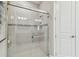 Bathroom featuring enclosed shower with glass doors, tiled walls, modern fixtures, and recessed lighting at 4257 Rosatti Rd, Wesley Chapel, FL 33543