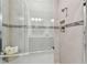 Modern shower with glass doors, tiled walls, and a built-in niche for toiletries at 4257 Rosatti Rd, Wesley Chapel, FL 33543