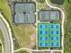 Aerial view of well-maintained tennis and pickleball courts with lush green surroundings in a vibrant community at 4257 Rosatti Rd, Wesley Chapel, FL 33543