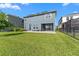 Grassy backyard featuring a covered patio and stylish furniture at 4583 Emprise Way, Land O Lakes, FL 34638