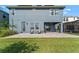 A backyard with a covered patio, and furniture set on a brick patio at 4583 Emprise Way, Land O Lakes, FL 34638