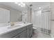 Bright bathroom featuring double sinks, a large mirror, and a bathtub with a shower at 4583 Emprise Way, Land O Lakes, FL 34638