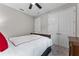 Cozy bedroom with a comfortable bed, ceiling fan, and closet with double doors at 4583 Emprise Way, Land O Lakes, FL 34638