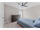 Cozy bedroom featuring a large dresser, ceiling fan, and large window at 4583 Emprise Way, Land O Lakes, FL 34638