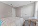 Neutral bedroom featuring two doors and a small table at 4583 Emprise Way, Land O Lakes, FL 34638